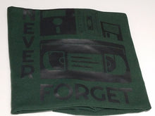 Load image into Gallery viewer, Black ink Never Forget design with cassette, VHS, and retro icons on forest green unisex short sleeve Chozzen Few cotton T-shirt